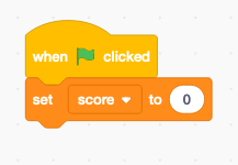 Scratch blocks showing set score to 0 block beneath when green flag clicked block.