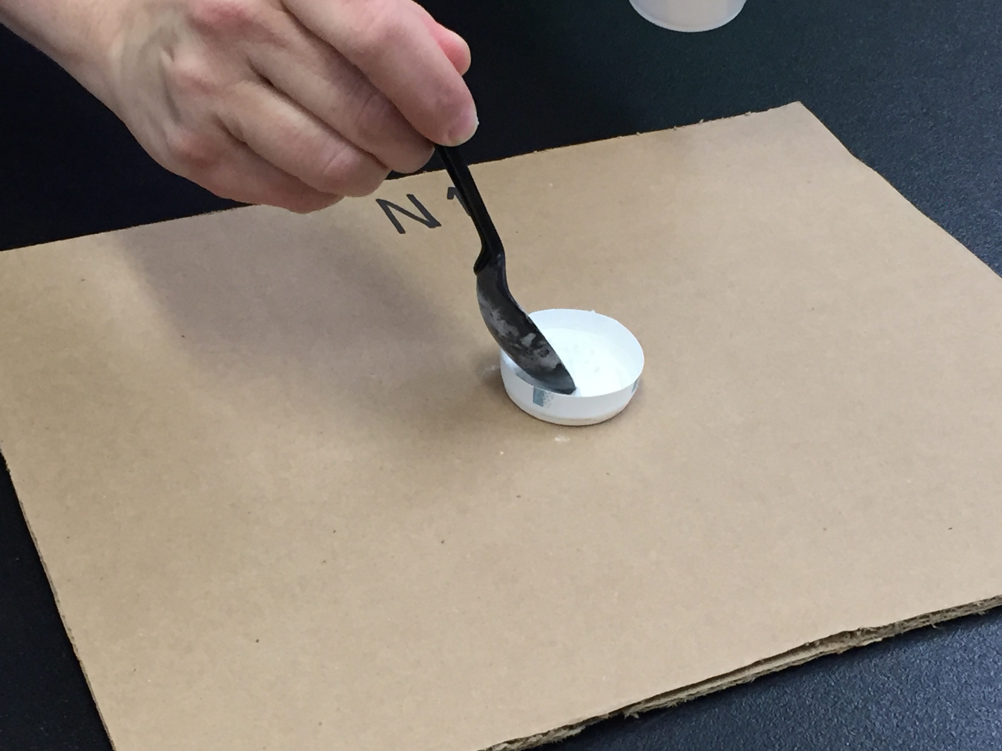 filling the cup with baking soda