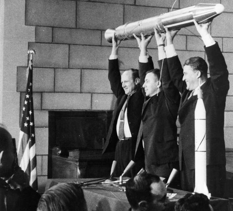 Pickering, Van Allen and Von Braun hold a model of Explorer 1 at a post-flight press conference.