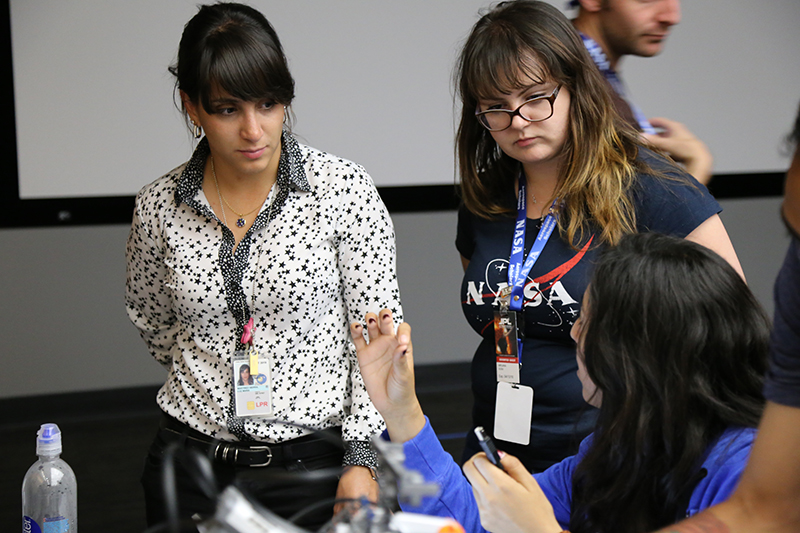 Luz Martinez Sierra speaks with students on her team