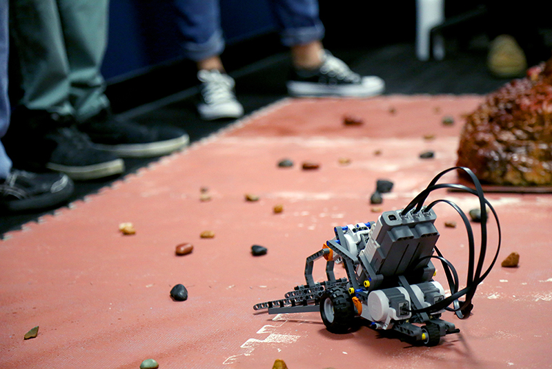 A team's rover collects rocks on the simulated Mars surface