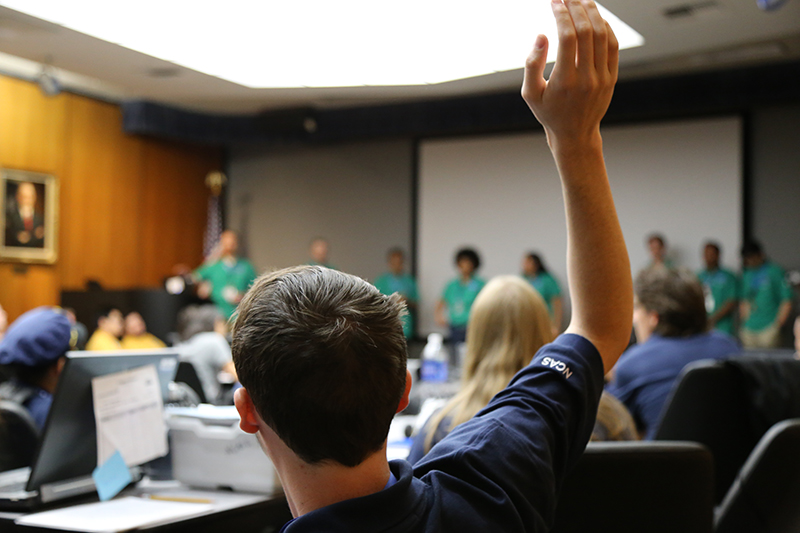 A student raises his hand to ask a question of the NCAS Green Team