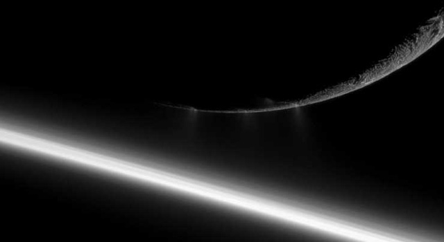 Saturn's moon Enceladus seen beyond Saturn's rings
