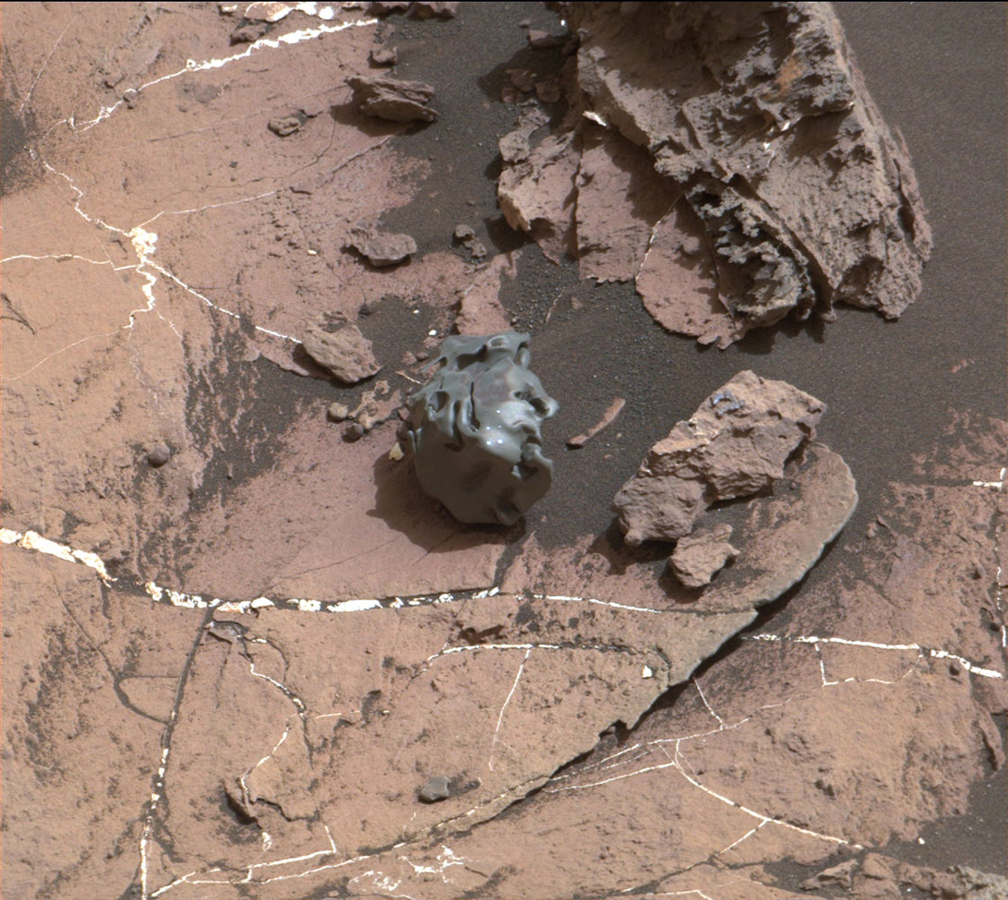 The dark, smooth-surfaced rock at the center of this Oct. 30, 2016, image from the Mast Camera (Mastcam) on NASA's Curiosity Mars rover was examined with laser pulses and confirmed to be an iron-nickel meteorite. It is about the size of a golf ball. Credit: NASA/JPL-Caltech/MSSS