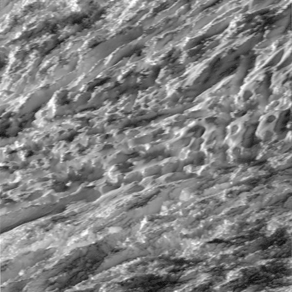During its closest ever dive past the active south polar region of Saturn's moon Enceladus, NASA's Cassini spacecraft quickly shuttered its imaging cameras to capture glimpses of the fast moving terrain below. This view has been processed to remove slight smearing present in the original, unprocessed image that was caused by the spacecraft's fast motion.