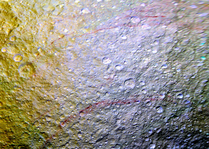 Unusual arc-shaped, reddish streaks cut across the surface of Saturn's ice-rich moon Tethys in this enhanced-color mosaic. The red streaks are narrow, curved lines on the moon's surface, only a few miles (or kilometers) wide but several hundred miles (or kilometers) long. The red streaks are among the most unusual color features on Saturn's moons to be revealed by Cassini's cameras.