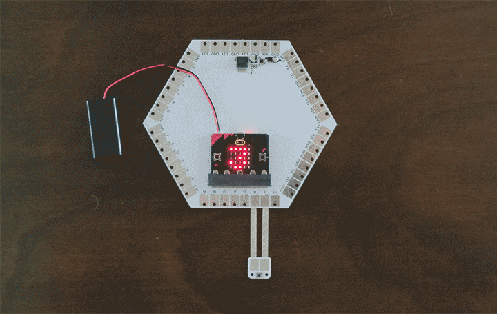 A microcontroller that displays an animated 3, 2, 1 countdown on an LED screen is connected to a button.