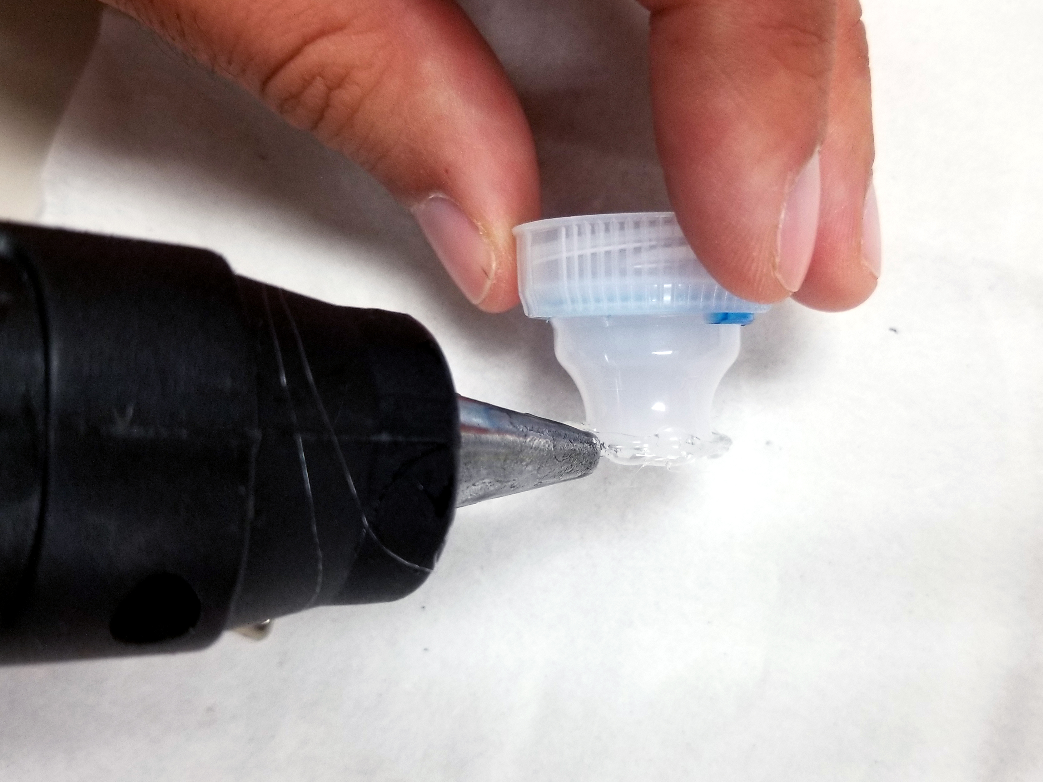 Adding glue on top of water bottle top