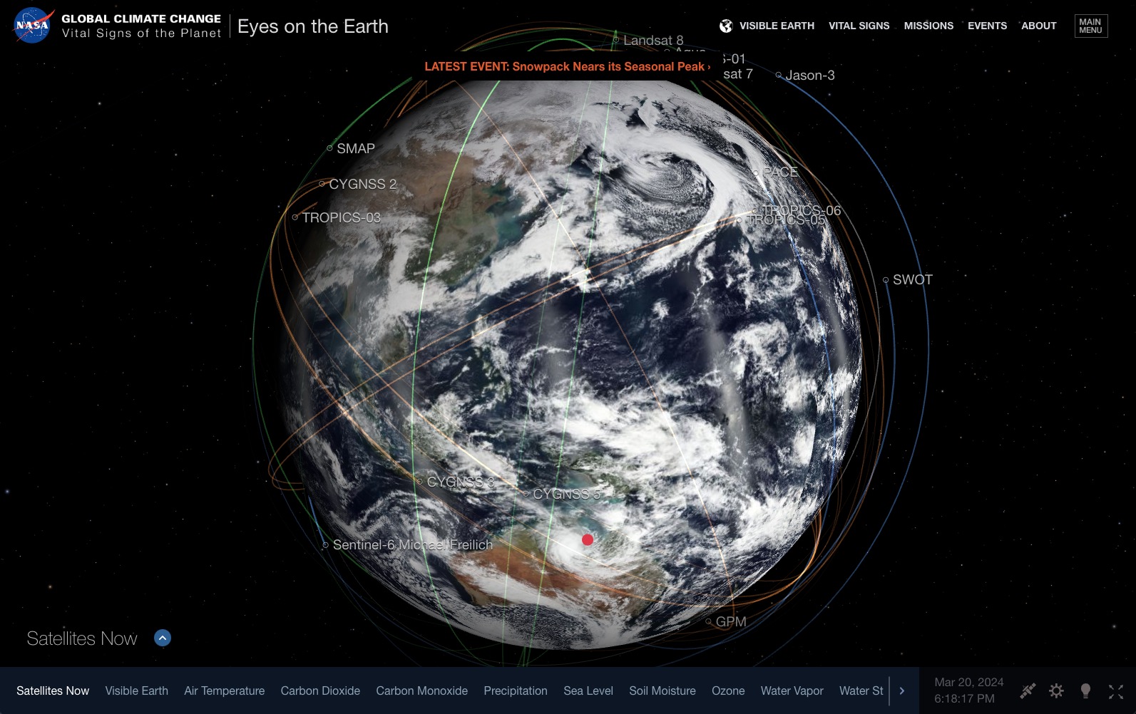Numerous lines representing the paths of satellites circle and crisscross a simulated view of Earth with controls and toggles lining sides of the image.