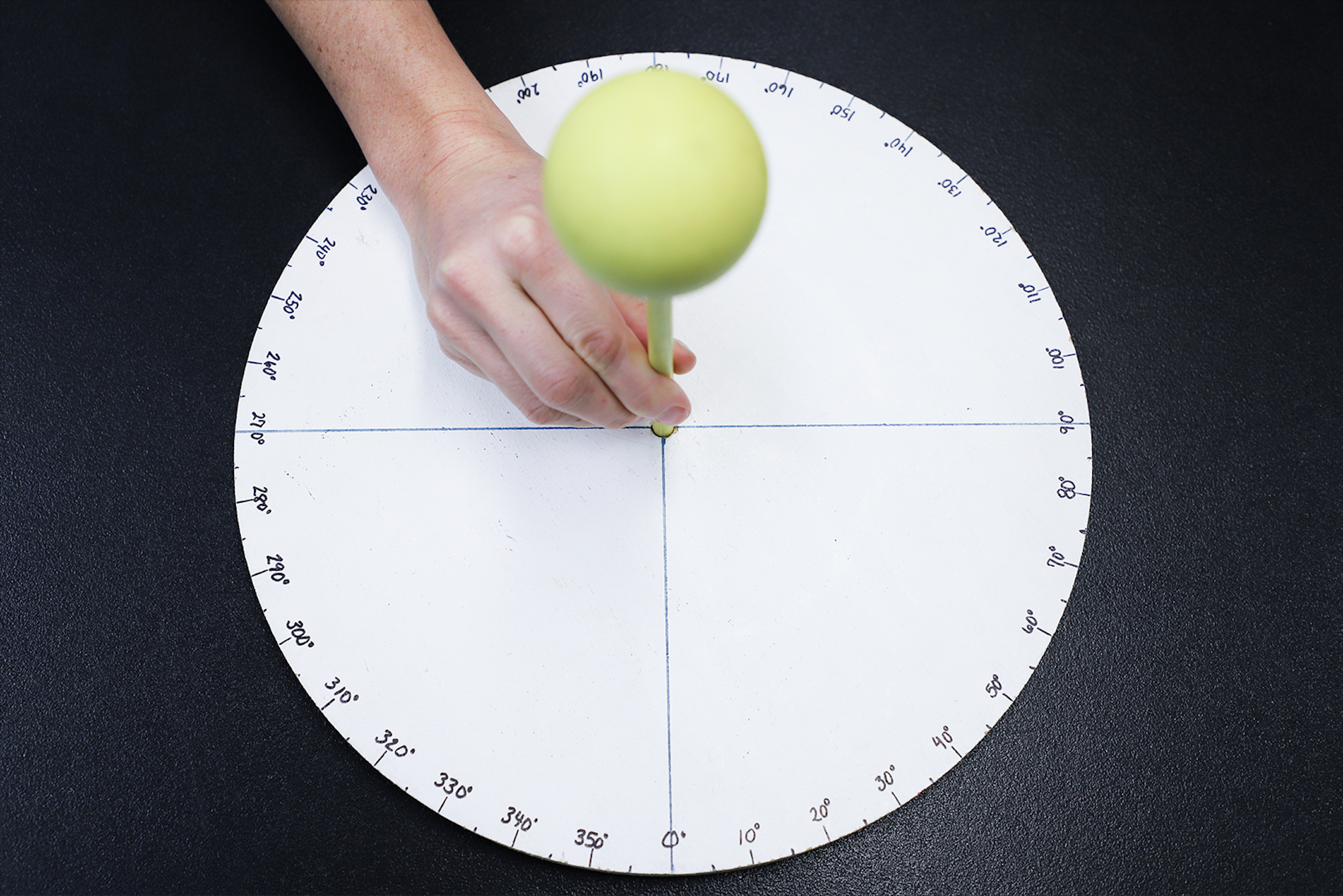 Hand placing the model sun in the center of the scale