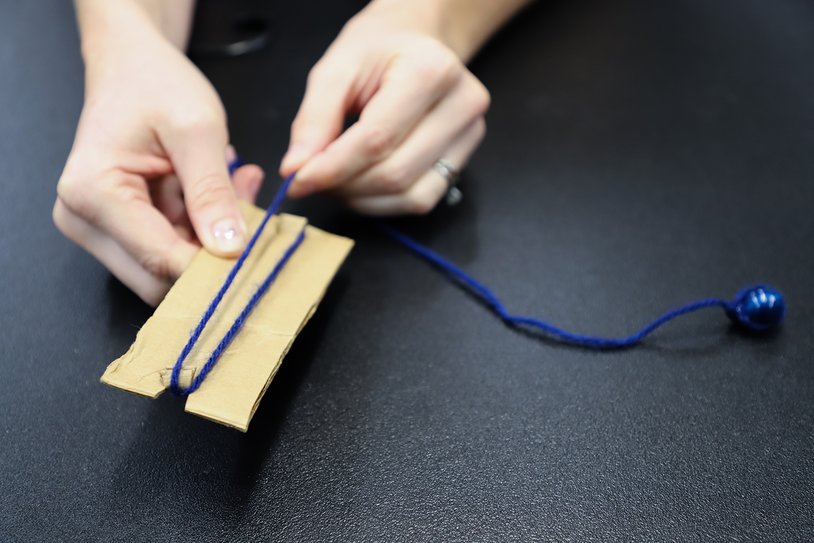 Wrapping the string around a piece of cardboard for easy storage