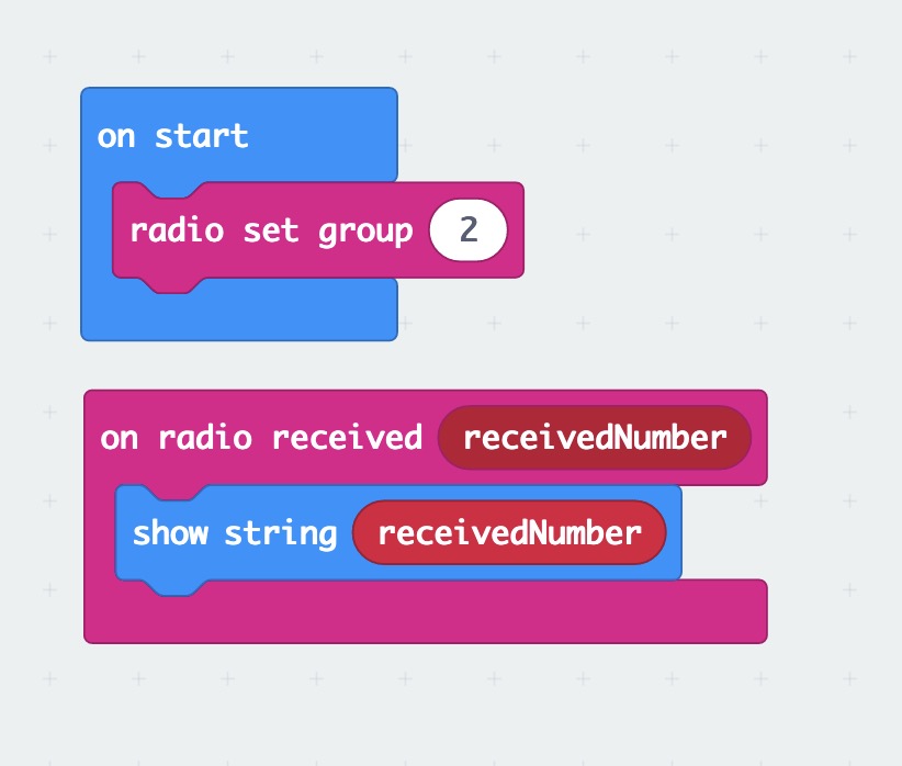 Screengrab of Makecode script with 'radio set group (2)' inside the 'on start' code block followed by 'show string [receivedNumber]' inside the 'on radio received [receivedNumber]' code block.