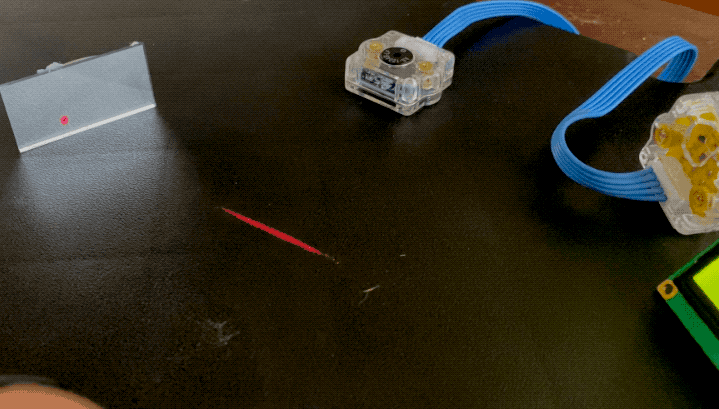 Animated image showing a laser aiming at a sensor until an indicator reads 'receiving' 
