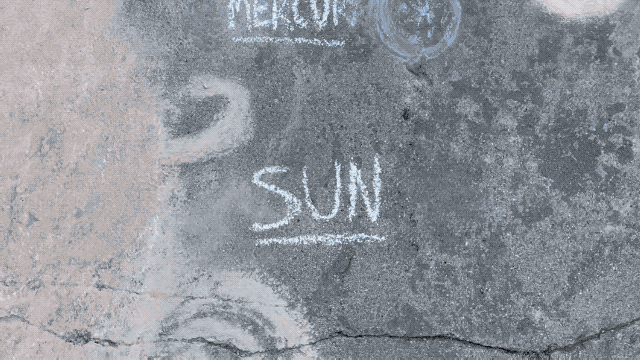 An animated image looking down as a person walks through a sidewalk chalk model of the solar system