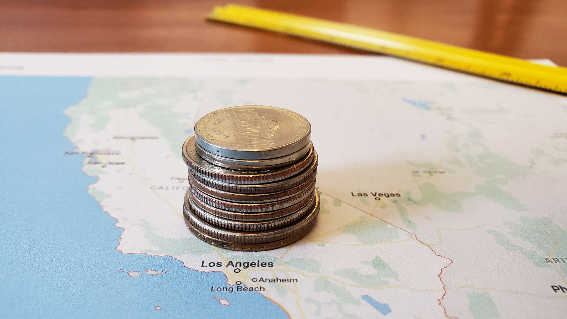 Coins stacked on top of a printed map of the Los Angeles area