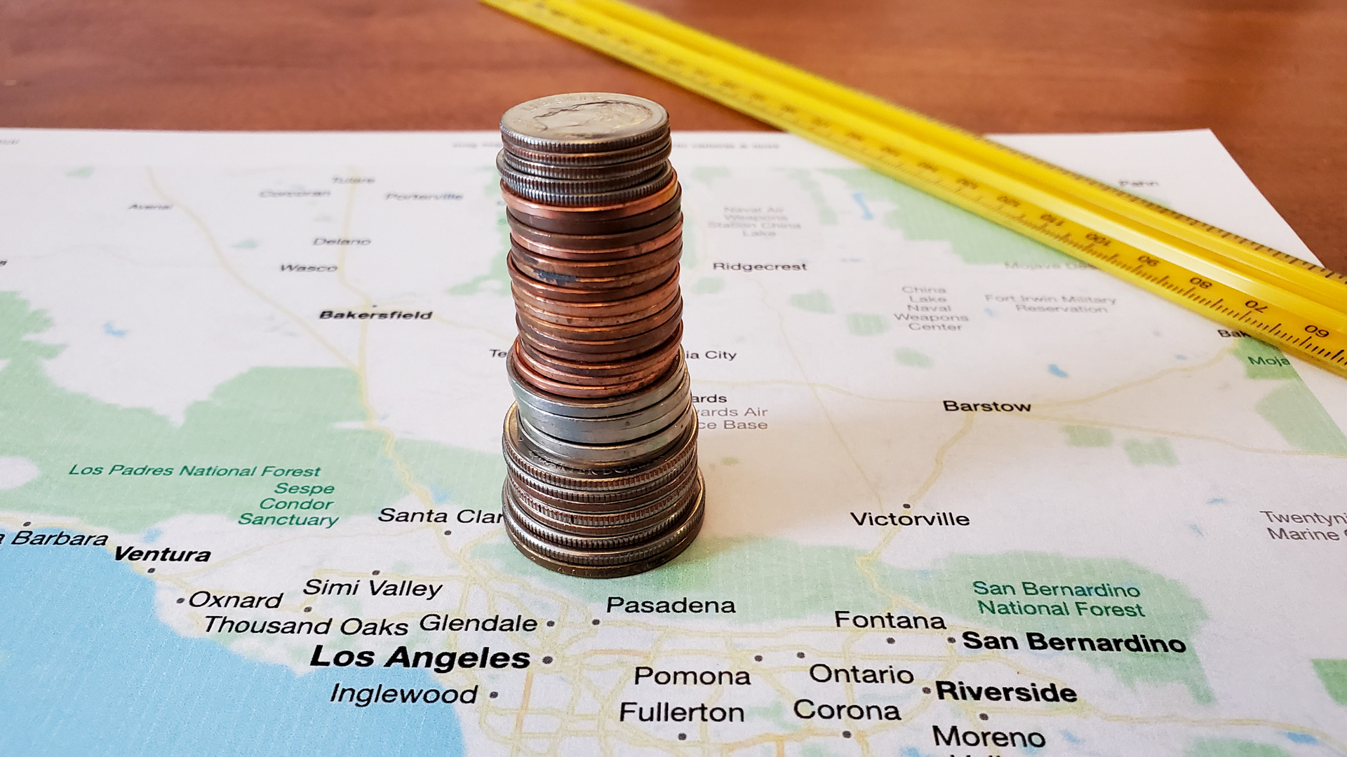 Coins stacked on a printed map of the Los Angeles area.