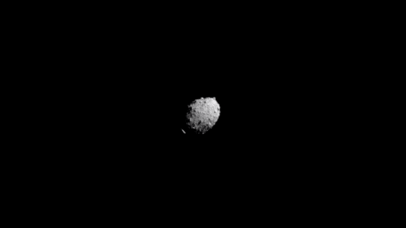 A rocky oblong-shaped asteroid gets closer and closer until the frame fills with a solid red.