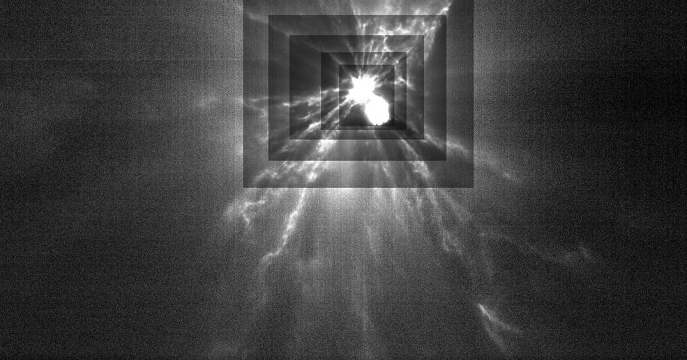 A flash of bright white with tendrils extending in all directions eminates from a more defined bright white blob. Overlapping rectangles show the object and ejecta in increasing contrast the closer they get to the center of the scene.