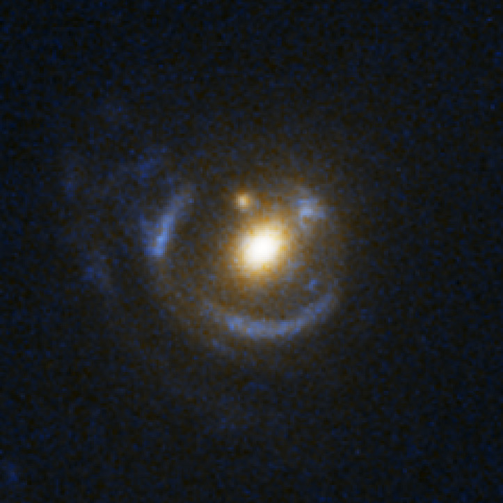 A bright central blob is surrounded by blue halos and whisps forming a sort of target pattern.