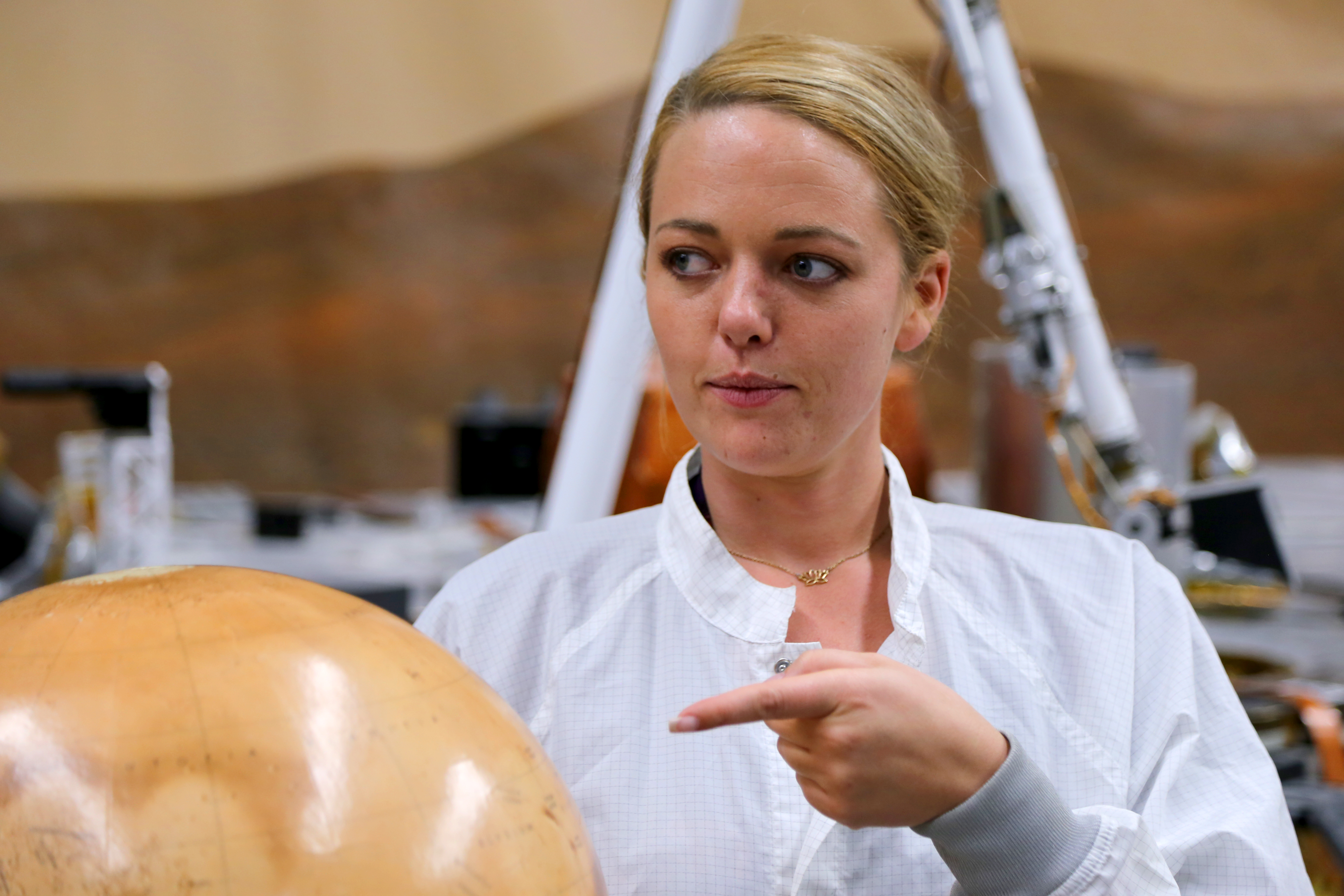 Heather Lethcoe points at a Mars globe