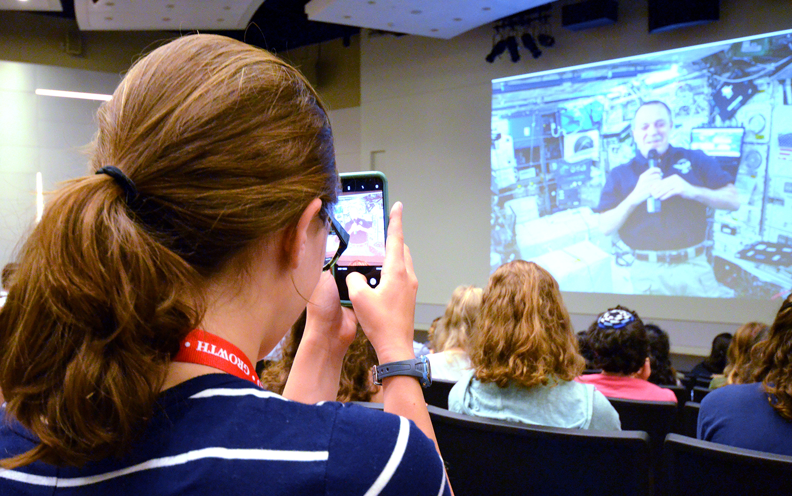 An intern takes a photo at the ISS Downlink watch party at JPL