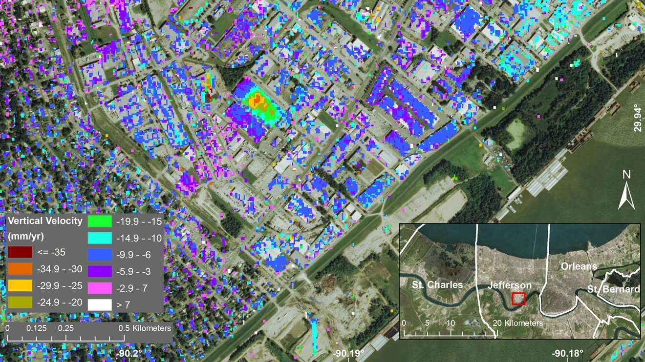 Specks of brightly covered squares dot an overhead image of Jefferson Parish, Louisiana. A key indicates how the colors correspond with the vertical velocity in mm/yr.