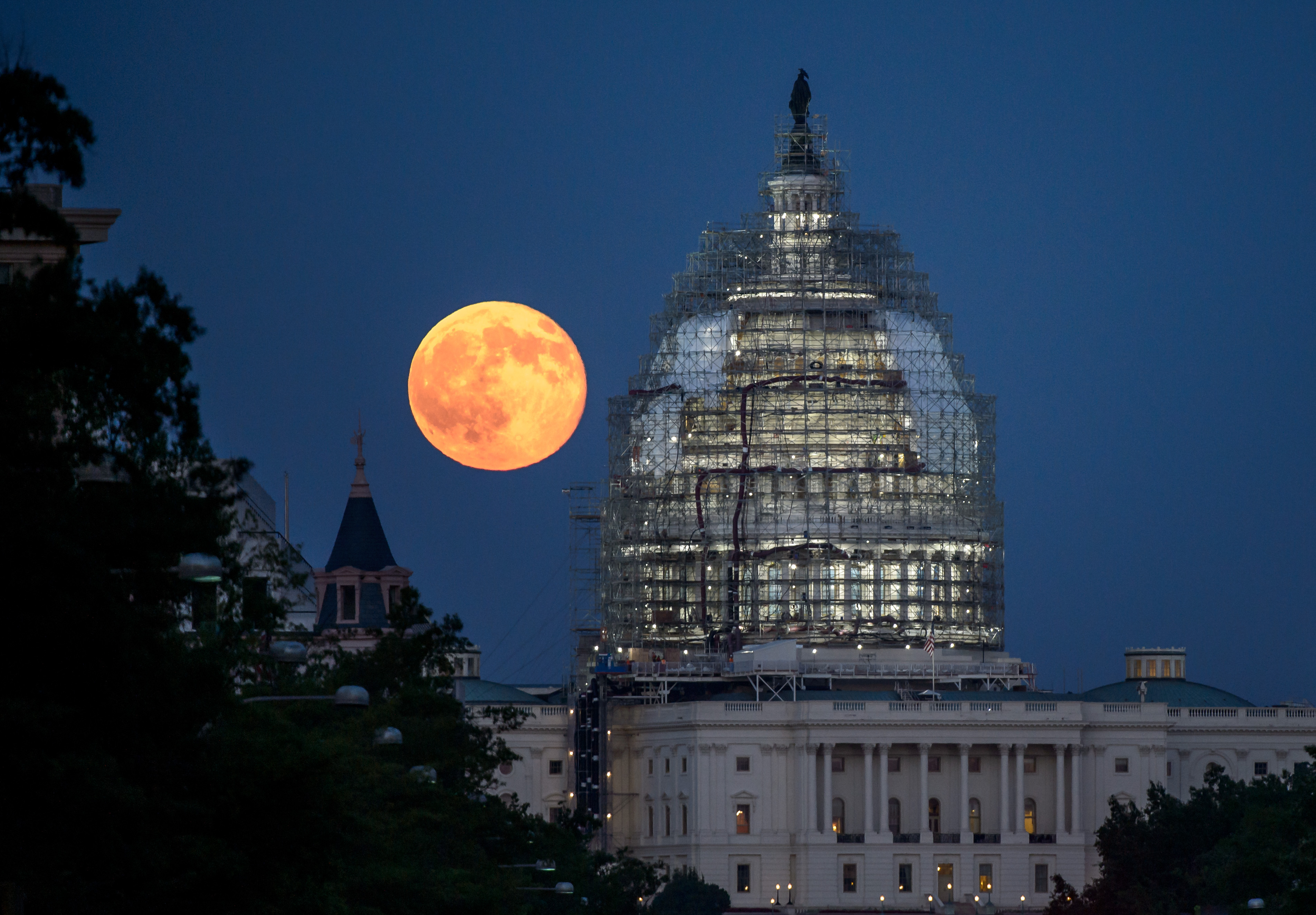 A nearly full Moon sets as the space shuttle Discovery sits atop Launch pad 39A at the Kennedy Space Center in Cape Canaveral, Florida, Wednesday, March 11, 2009. Photo Credit: (NASA/Bill Ingalls