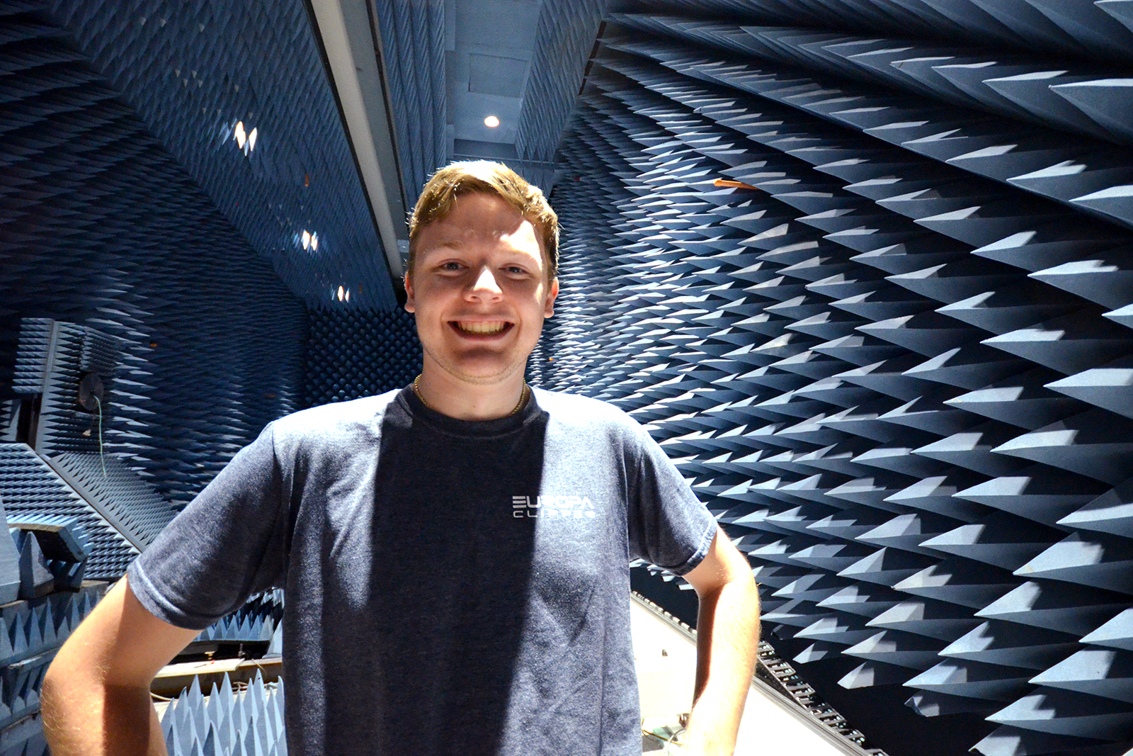 Zachary Luppen stands in an anechoic chamber at JPL