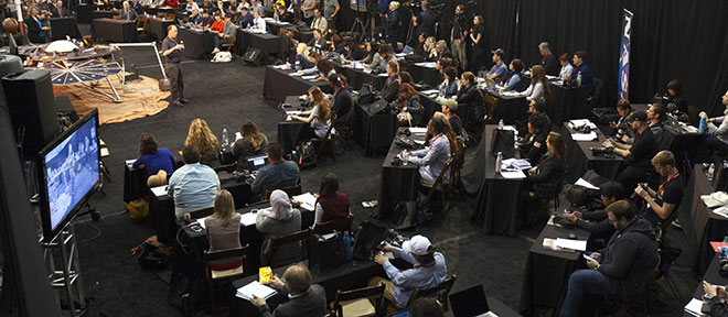 Media team shown sitting in mission control