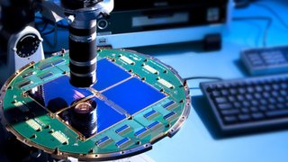 The BICEP2 telescope at the South Pole used a specialized array of superconducting detectors to capture polarized light from billions of years ago. The detector array is shown here, under a microscope.