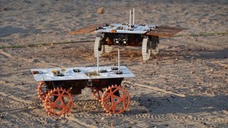 Two full-scale development model rovers that are part of NASA's CADRE (Cooperative Autonomous Distributed Robotic Exploration) technology demonstration drive in the Mars Yard at the agency's Jet Propulsion Laboratory in Southern California in August 2023.