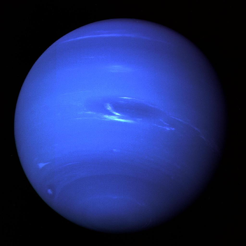 The image of Neptune shows the Great Dark Spot and its companion bright smudge; on the west limb the fast moving bright feature called Scooter and the little dark spot are visible in this image obtaind by NASA"s Voyager 2.