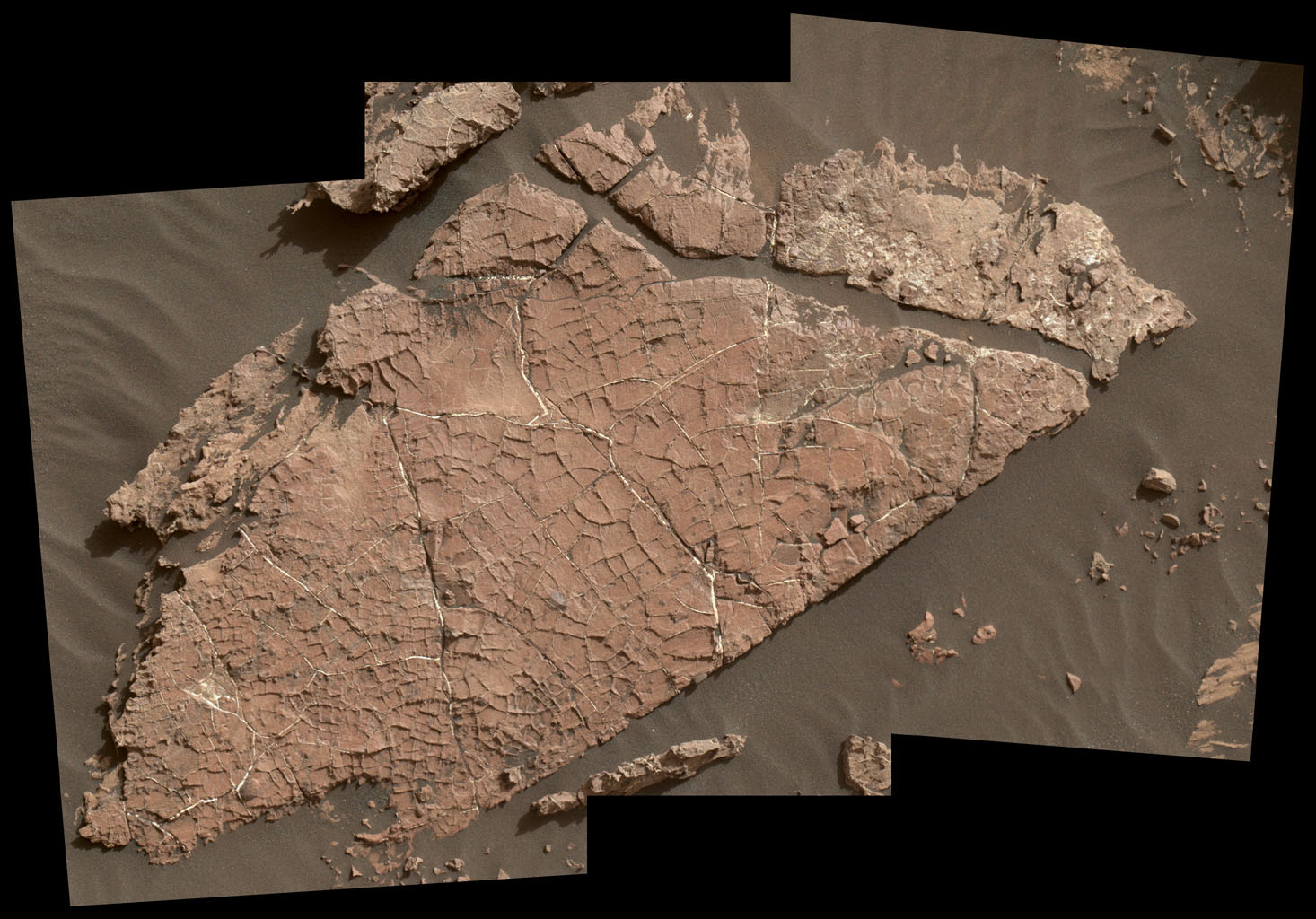 The network of cracks in this Martian rock slab called 'Old Soaker' may have formed from the drying of a mud layer more than 3 billion years ago. The view combines three images taken by NASA's Curiosity Mars rover on Dec. 31, 2016.