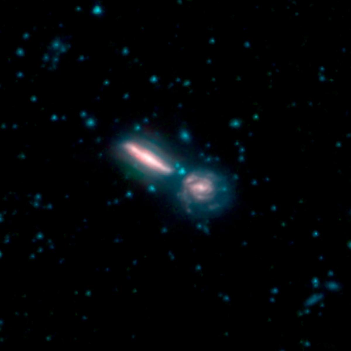 This image, by NASAs Spitzer Space Telescope, shows two merging galaxies known as Arp 302, also called VV 340.