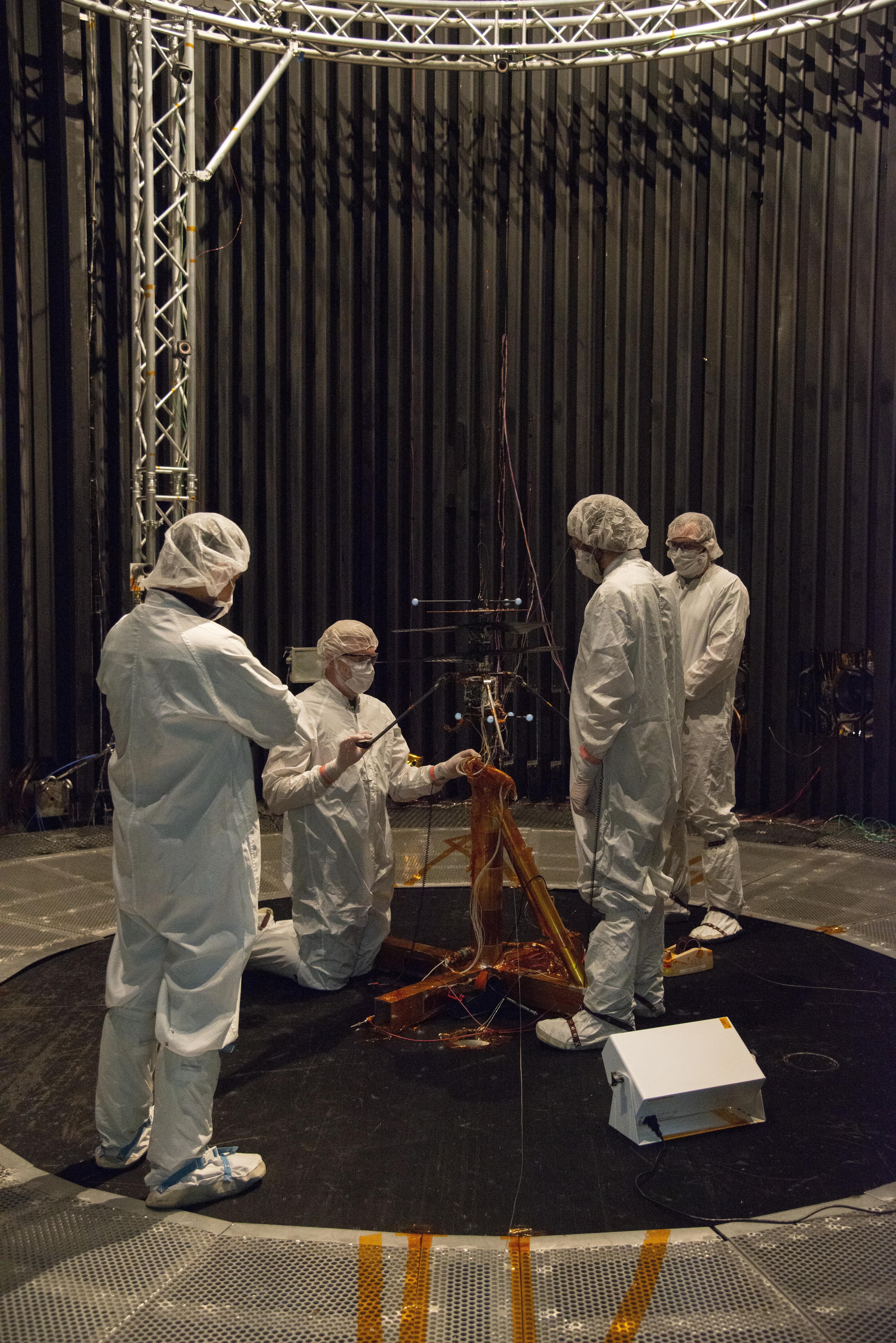 Members of NASAs Mars Helicopter team prepare the flight model for a test in the Space Simulator at NASAs Jet Propulsion Laboratory in Pasadena, California.